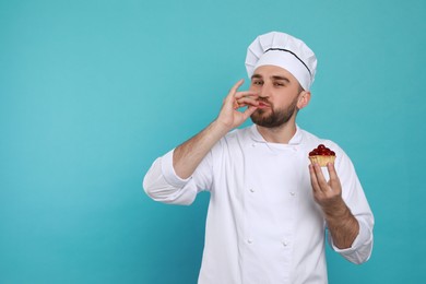 Photo of Happy professional confectioner in uniform with tartlet showing delicious gesture on light blue background. Space for text
