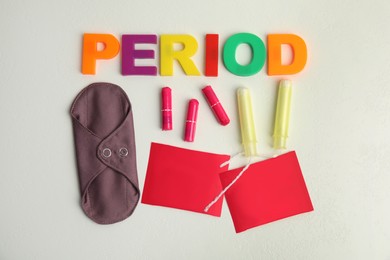 Tampons and other period products on white background, flat lay