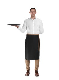 Full length portrait of happy young waiter with tray on white background