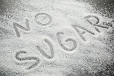 Photo of Composition with phrase NO SUGAR on grey table