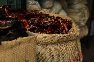 Photo of Pile of dried guajillo peppers in burlap, closeup