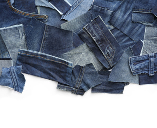 Many patches of old jeans on white background, top view