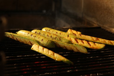 Cooking delicious fresh zucchini on grilling grate in oven