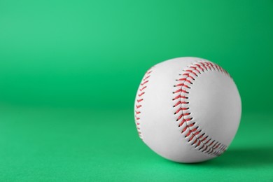 Photo of Baseball ball on green background, closeup with space for text. Sports game