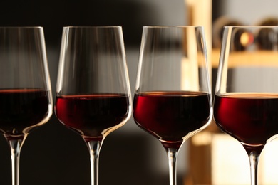 Glasses of red wine in cellar, closeup. Expensive drink
