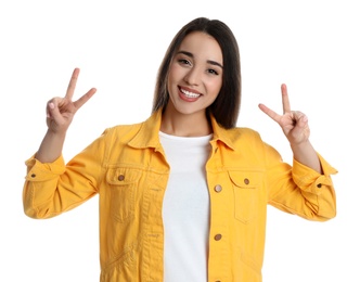Woman in yellow jacket showing number four with her hands on white background