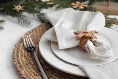 Photo of Beautiful festive place setting with stylish decor for Christmas dinner on white wooden table, closeup