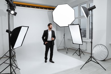 Photo of Handsome model posing in modern studio. Professional photo session