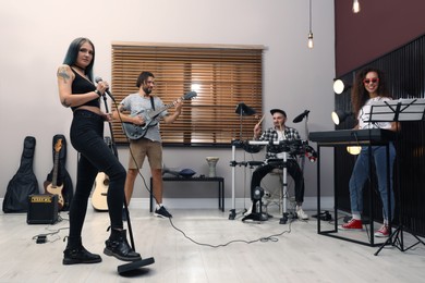 Music band performing in modern recording studio