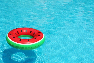 Inflatable ring floating in pool on sunny day