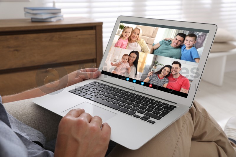 Man having online meeting with family members via videocall application at home, closeup