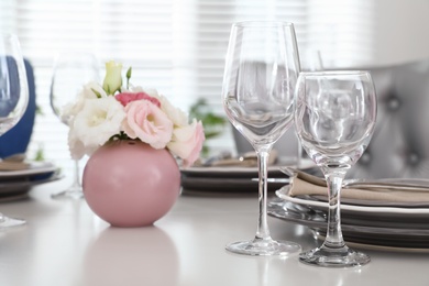 Photo of Beautiful table setting in modern dining room interior