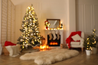 Fireplace in beautiful living room decorated for Christmas, blurred view