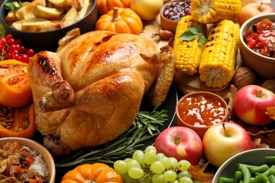 Traditional Thanksgiving day feast with delicious cooked turkey and other seasonal dishes as background, closeup