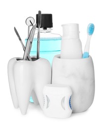 Many different teeth care products and dental tools on white background