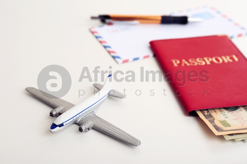 Composition with toy plane, passport and money on white background. Travel insurance