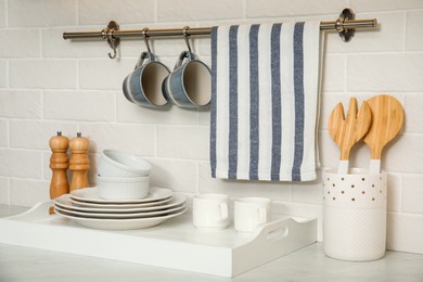 Clean towel, utensils and dishware in kitchen