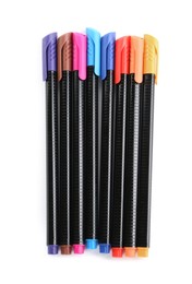 Many colorful markers on white background, top view. School stationery