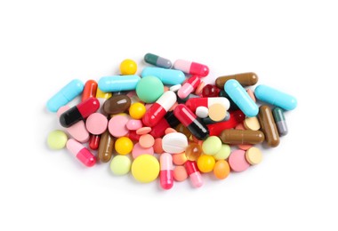 Heap of different colorful pills isolated on white, top view
