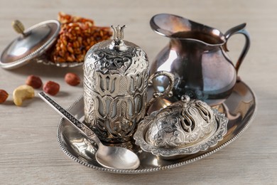 Photo of Tea and Turkish delight served in vintage tea set on wooden table