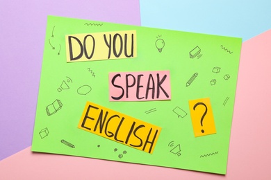 Note with question Do You Speak English on color background, top view