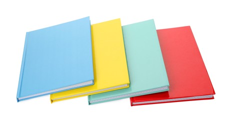 Different colorful hardcover planners on white background