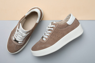 Stylish brown shoes on color background, flat lay