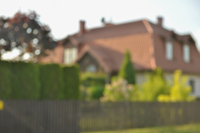 Photo of Blurred view of beautiful house and green shrubberies