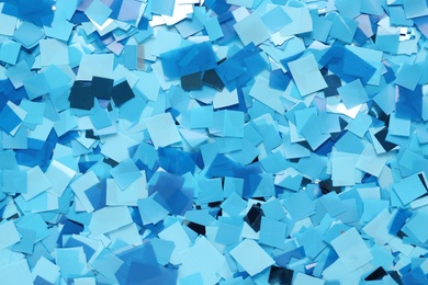 Light blue confetti as background, top view