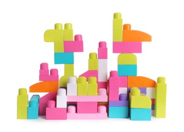 Toy castle made of bright building blocks on white background