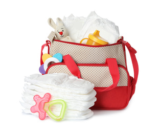 Maternity bag with disposable diapers and child's accessories on white background