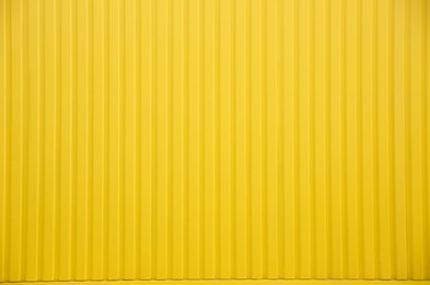 Bright yellow fence as background, closeup view