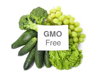 Tasty fresh GMO free products and paper card on white background, top view