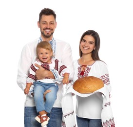 Happy Ukrainian family in embroidered shirts with korovai bread on white background