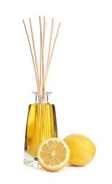 New reed air freshener and lemons on white background