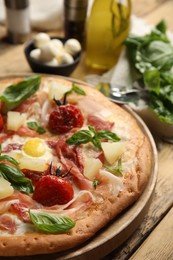 Pita pizza with prosciutto, pineapple, grilled tomatoes and egg on wooden table, closeup