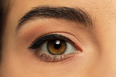 Photo of Young woman with permanent eyeliner makeup, closeup