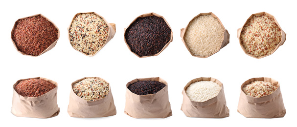 Set with different types of rice in paper bags on white background. Banner design