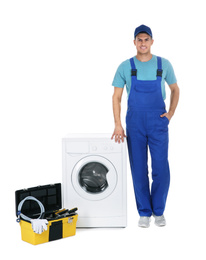 Repairman with toolbox near washing machine on white background