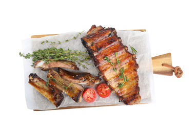 Photo of Tasty grilled ribs with thyme and tomatoes isolated on white, top view