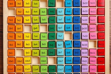 Photo of Colorful math game kit with arithmetical tasks on wooden table, top view
