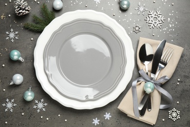 Beautiful Christmas table setting and festive decor on grey background, flat lay