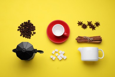 Photo of Flat lay composition with roasted beans and geyser coffee maker on yellow background