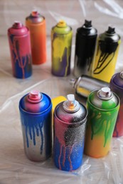 Used cans of spray paints on floor. Graffiti supplies