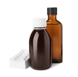 Photo of Bottles of syrups with pills on white background. Cough and cold medicine