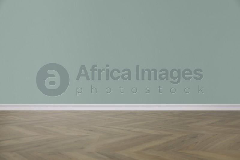 Image of Wooden floor and empty color wall indoors