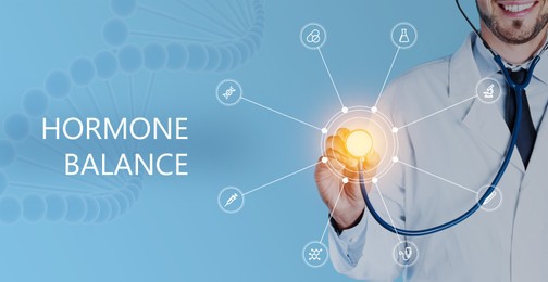 Doctor holding stethoscope and virtual screen with inscription Hormone Balance and digital icons on light blue background, closeup