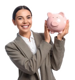 Happy young businesswoman with piggy bank on white background