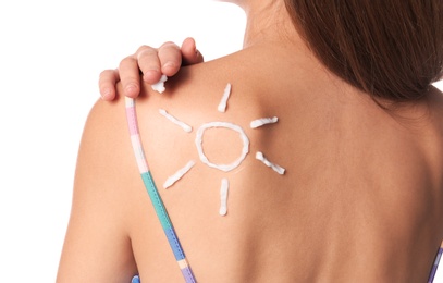 Woman with sun protection cream on body against white background, closeup