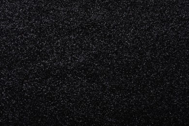 Beautiful shiny black glitter as background, closeup